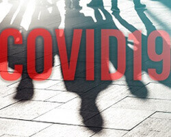 The word "COVID19" in red block letters across a background of shadows of people. 