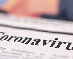 A closeup of a newspaper with the word "Coronavirus" visible in the headline.