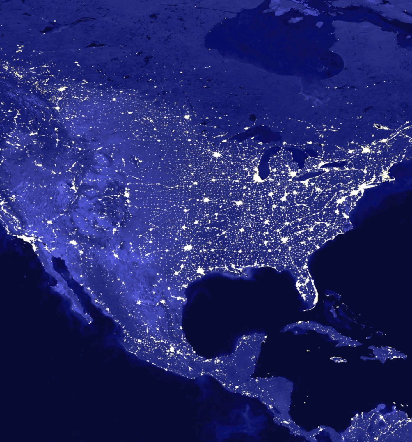 Map of the United States as shown by illuminated electrical lights on a dark blue background. 