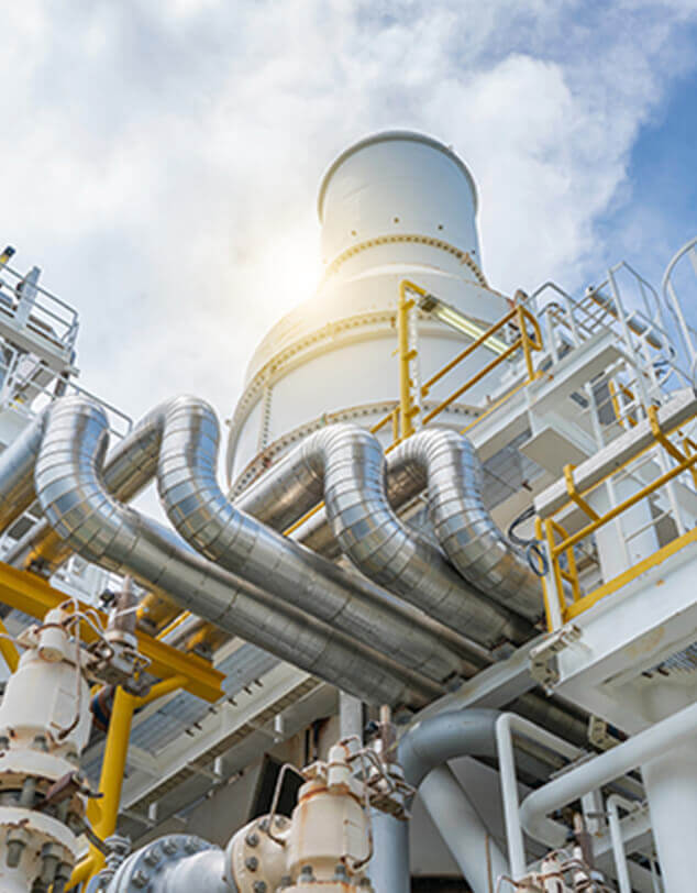 Industrial tubes, ducts, valves, and exhaust pipes at a chemical processing facility. 