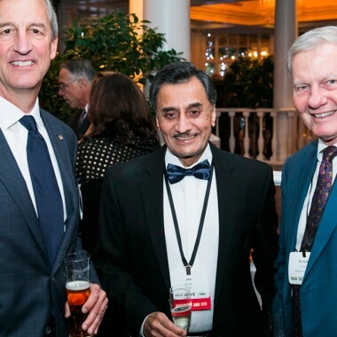 A group of businesspeople talking and smiling at ANSI Awards reception. 