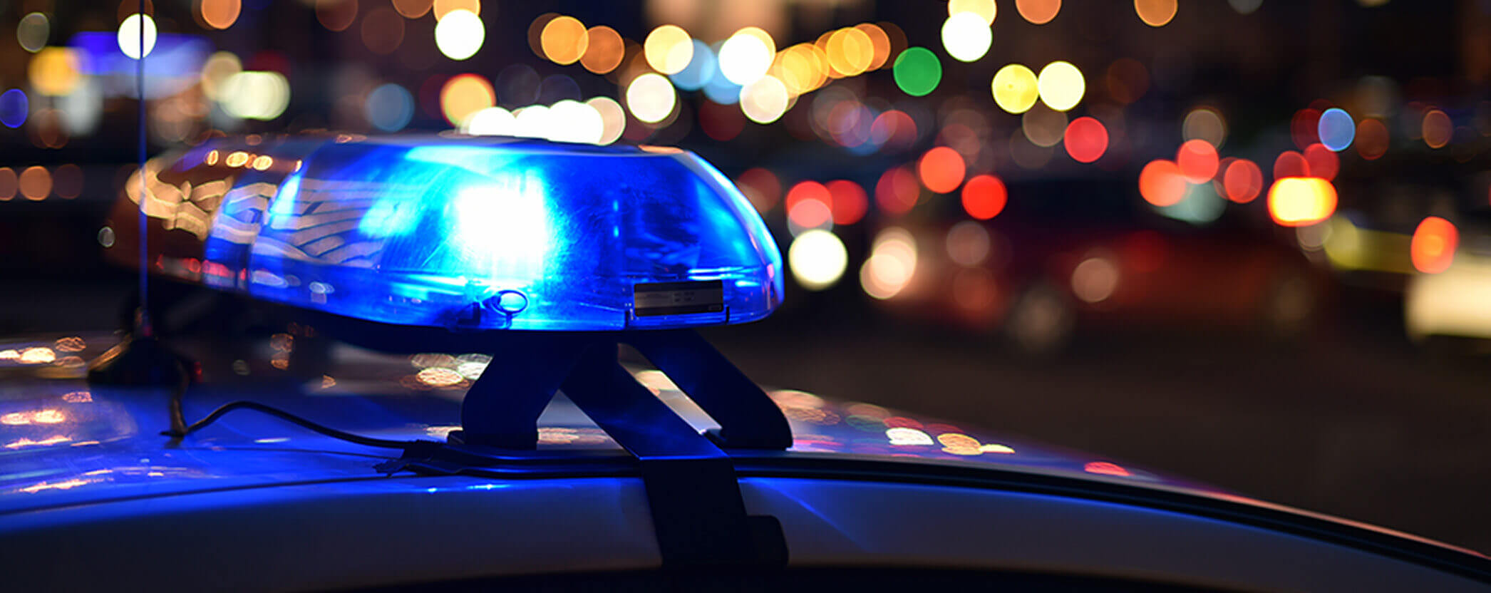 Blue light atop a police car at night
