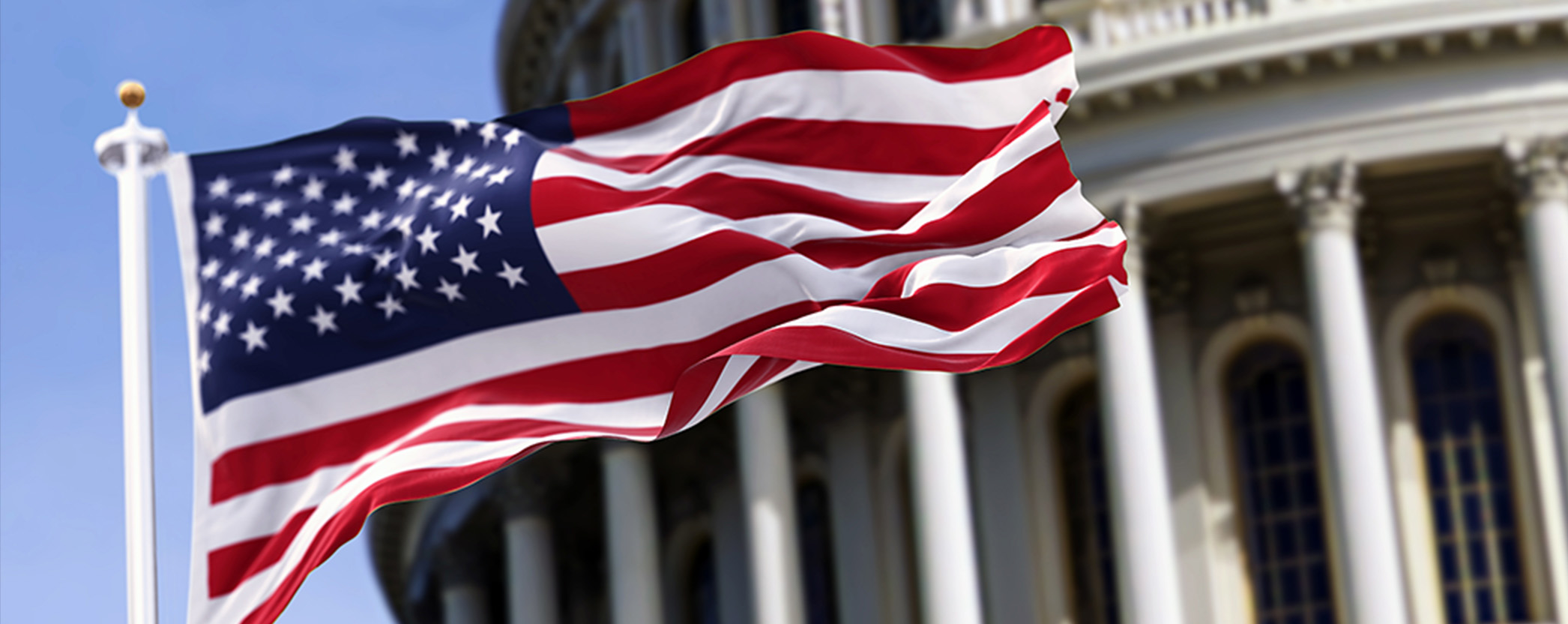 american flag against a blurred capitol building background